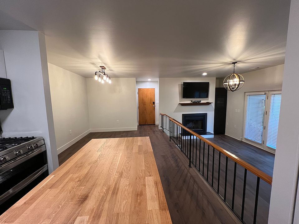 View from kitchen into dinning and living area accompanied by view into the patio.