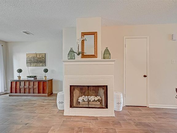 A WOOD BURNING FIREPLACE IS A UNIQUE FEATURE OF THIS UNIT.