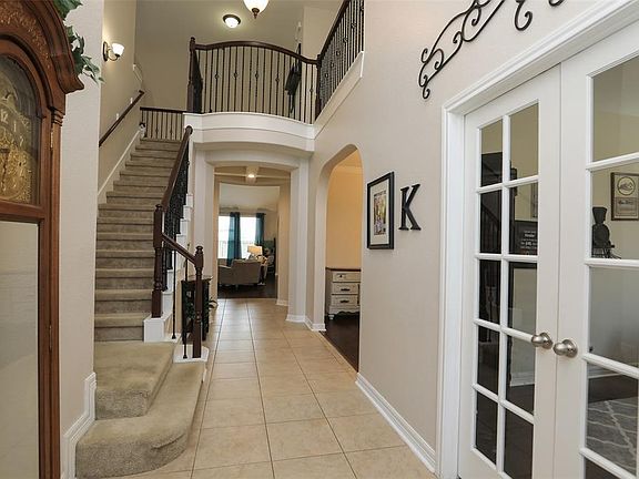 As you enter you will immediately notice the soaring ceilings, crown molding, sweeping staircase with wrought iron spindles and neutral colors.