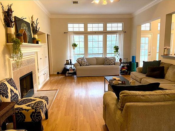 Open floorplan- living room with fireplace and large recessed tv cabinet