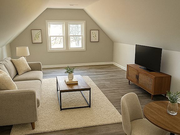 The kitchen opens into the large living room and eating area with new vinyl plank throughout