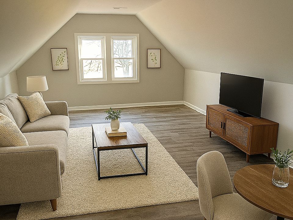 The kitchen opens into the large living room and eating area with new vinyl plank throughout