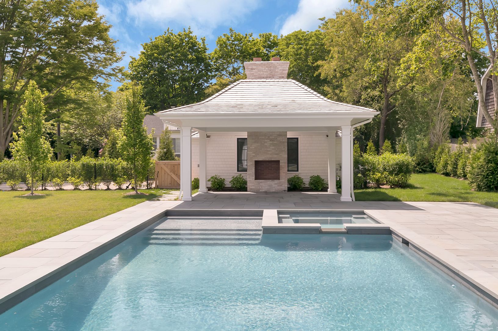 Pool, patio, spa and pavilion with outdoor fireplace