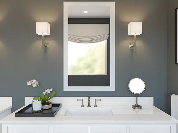 Primary bath with white-framed mirror
