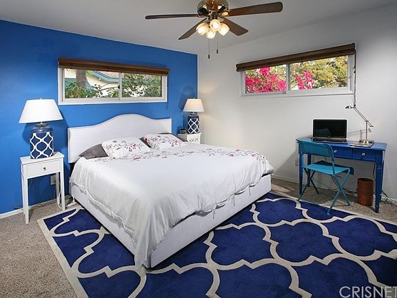 The large master suite is drenched in natural ligh