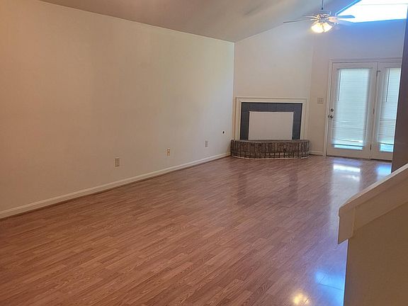 Large living room with vaulted ceilings and great natural light.
