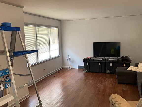 living room, but the floors are sanded to match the others light color of the bedrooms