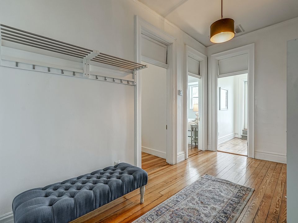 Large front atrium leading to hallway and three bedrooms. Includes closets/storage units.