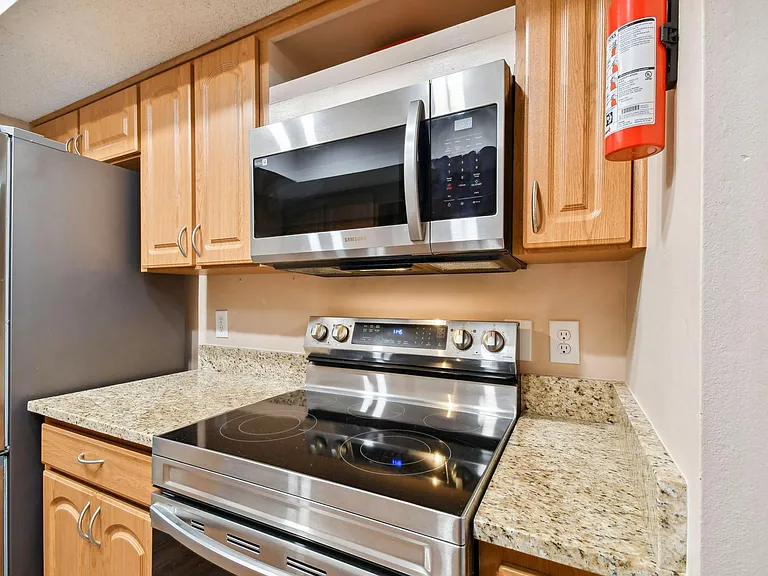 Updated kitchen with granite counter tops and stainless steel appliances