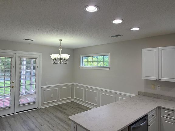 Kitchen with large eatin area. French door opens to back porch. Lots of natural light in the kitchen.