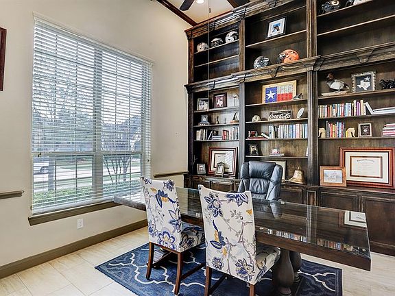 There are upgraded tile floors in the lower level. The study has French glass doors and a wall of custom made book shelves, high beamed ceilings, extensive crown molding and is in the front of the home, so you can look out while you work.