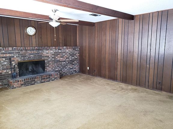 large, paneled den with fireplace. Opens to private, covered patio with patio furniture - quality table and 4 chairs.