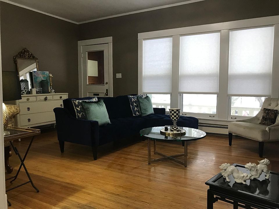 Spacious living room arena with large front window, fireplace and coat closet.