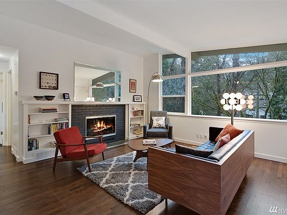 Pristine living room -- check out the window -- loads of light.  Stunning hardwoods and warm and cozy fireplace. 