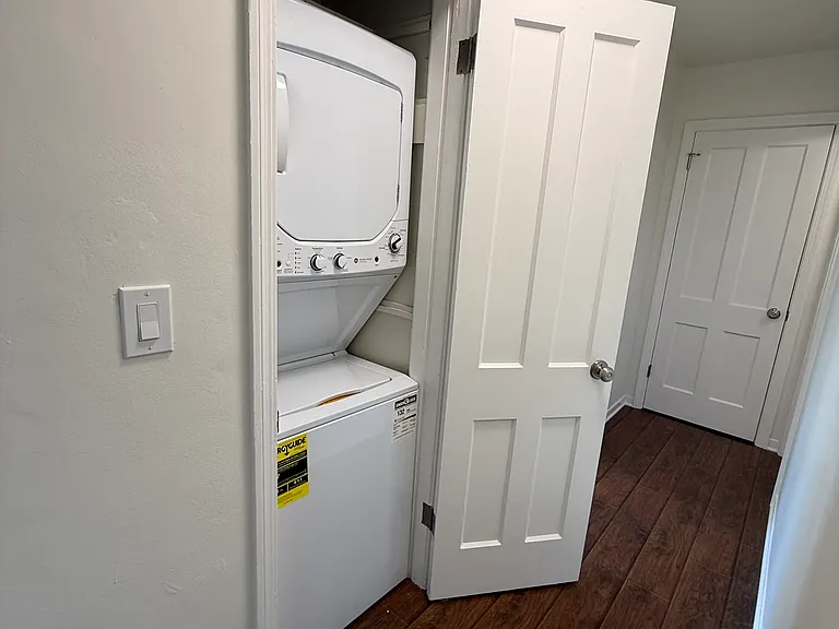 Laundry closet located in the hallway.