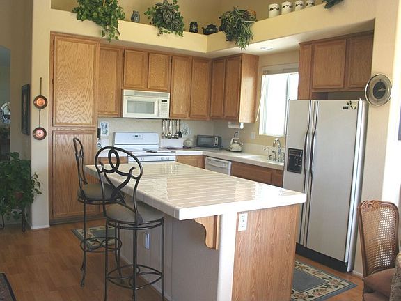 Upgraded kitchen appliances, laminate wood flooring, and island.