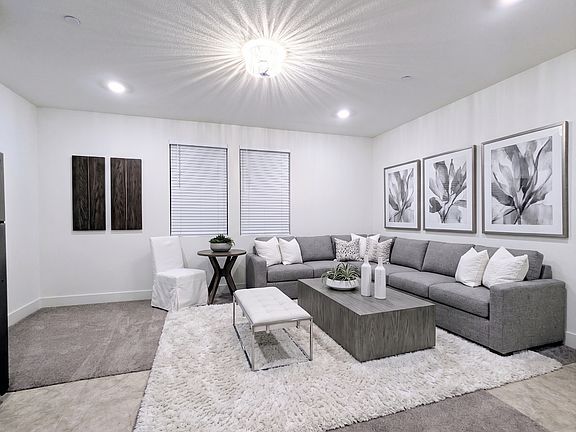 Spacious and versatile living area with upgrade light feature. This room easily accommodates a full-size sectional sofa and a dining table, offering the perfect setup to relax, work, or entertain in style. Your blank canvas for creating your ideal home.