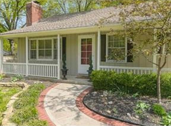 The brick lined walkway leads you to the home and charming front