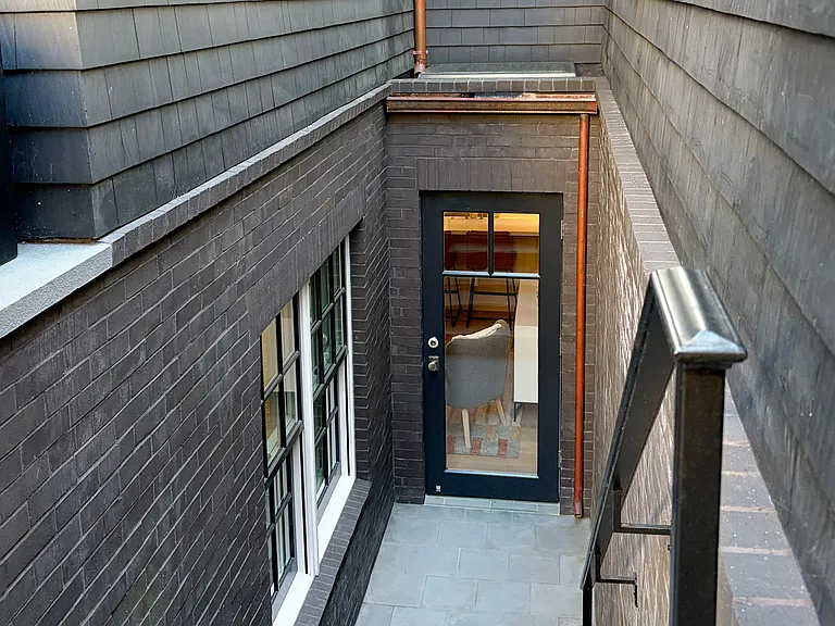 Rear Patio (private) Showing Back Door, Bedroom Windows & Skylight. Door has Hook to Keep Open for Fresh Air