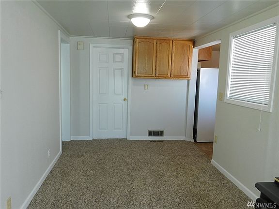Large dining room with overhead cabinets.  New mini blinds in all rooms.  Also new vinyl windows throughout the home.