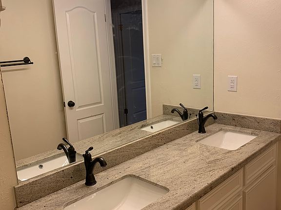 Bathroom with granite countertops and double sinks