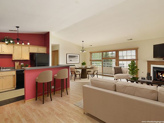 Virtually staged to show furniture placement. Gas fireplace, doors to balcony.