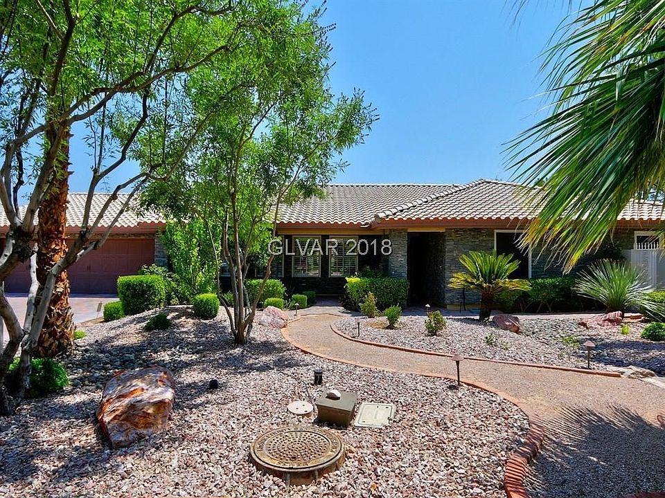 Beautiful custom single story home on 1/2 acre, with stacked granite stone front, park like landscape, located at the end of the