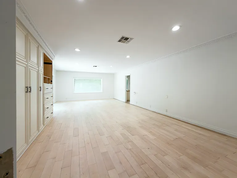 Generous closet built-ins and a bright window make this unfurnished bedroom shine in a Beverly Hills luxury rental at 1094 Garden Lane, a 90210 home for rent.