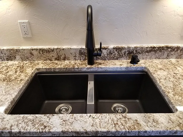 Desert beach 3 cm granite top with deep sink and fixtures.