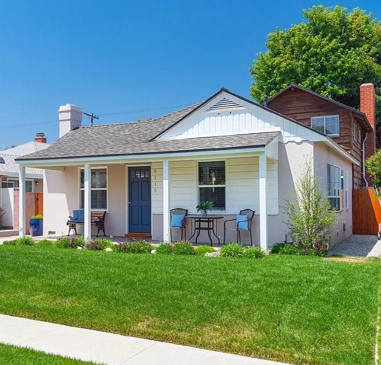 Large font yard with front porch and manicured yard.