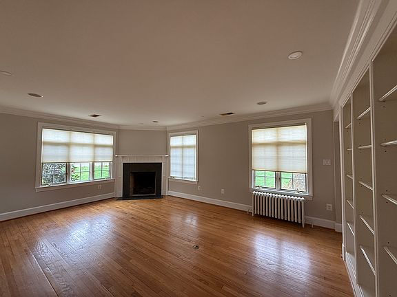 Family room with wood burning fireplace, built in shelving