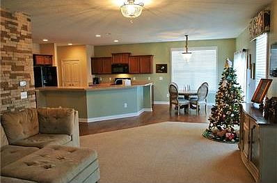 Warm family room with accent wall opens to kitchen and den