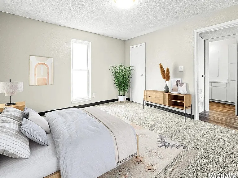Bright and cozy bedroom with plush carpeting, modern furnishings, and a serene ambiance, showcasing virtual staging.