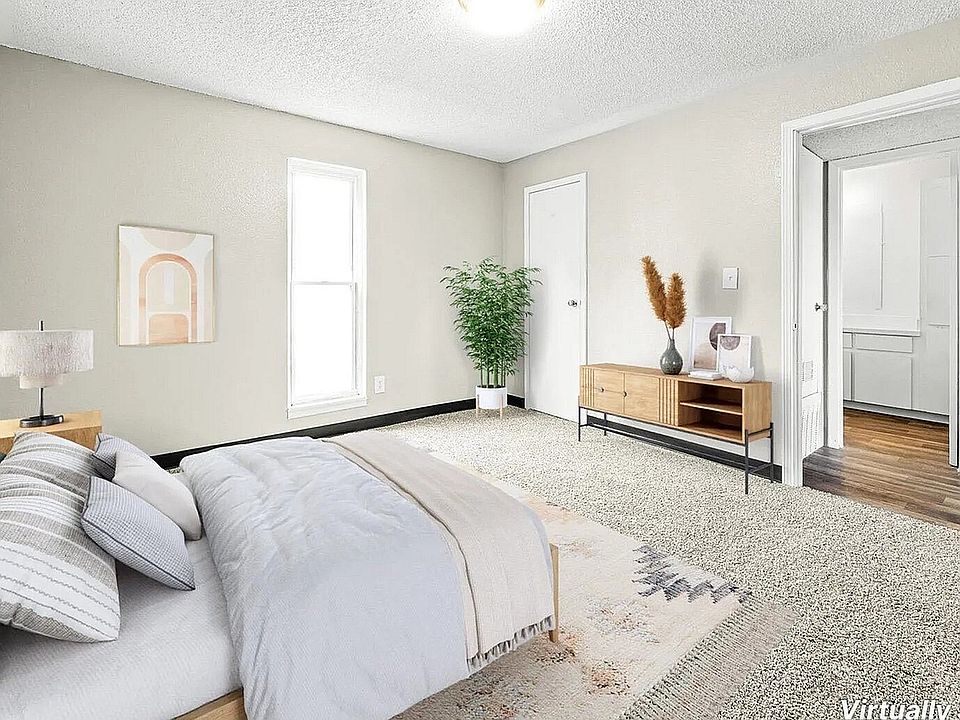 Bright and cozy bedroom with plush carpeting, modern furnishings, and a serene ambiance, showcasing virtual staging.
