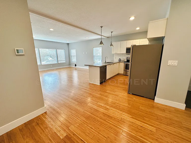 Dining Area view looking into Kitchen and Living Room Area.