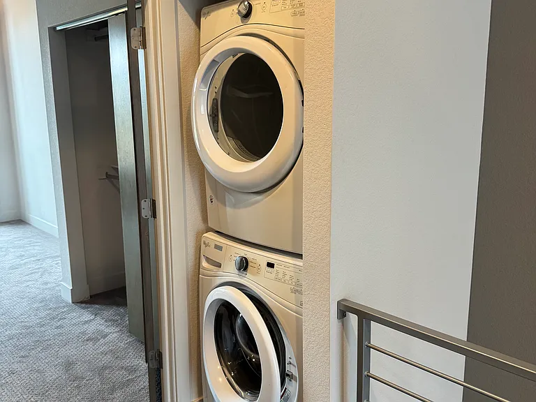 Full-Sized Washer and Dryer Adjacent to Bedroom
