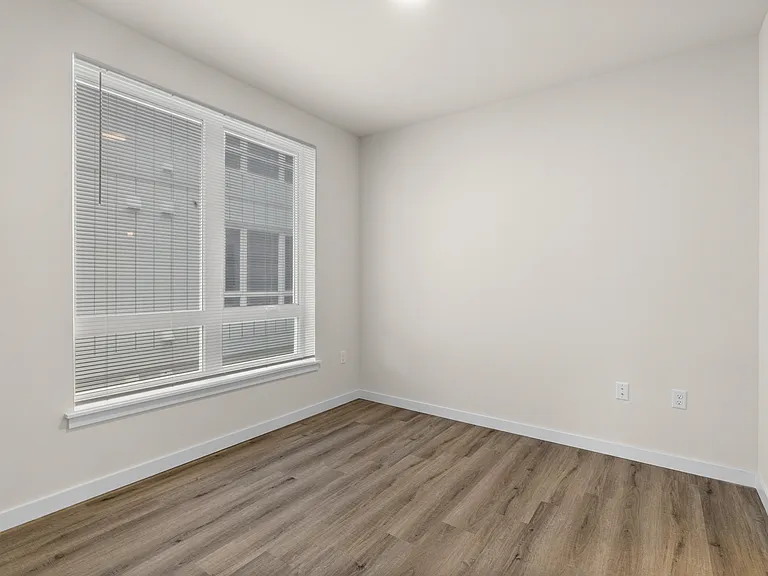 Cozy bedroom with natural light and modern flooring. Cozy bedroom with natural light and modern flooring.