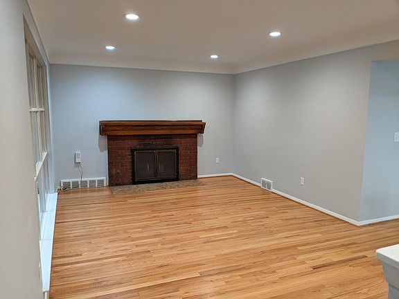 Living Room with Fireplace and new lighting - fresh paint - refinished hardwood floors