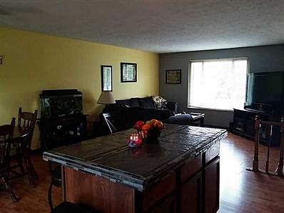 Living Room. Center island with tile surface provides extra seating and work space.