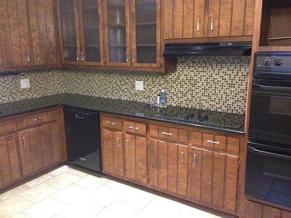 Kitchen w/ granite counters and tile backsplash