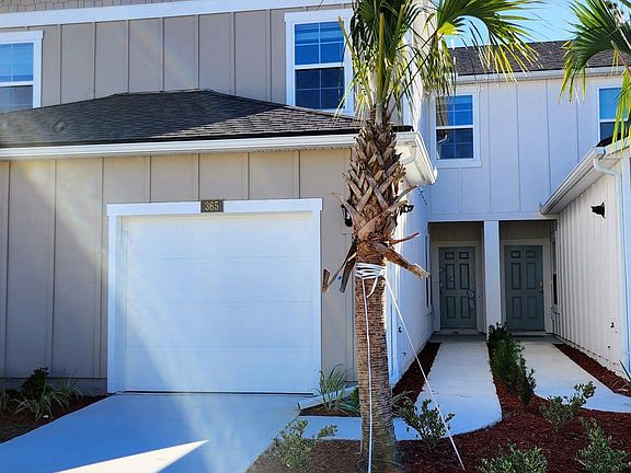 Front Elevation with Gorgeous Palm Trees.