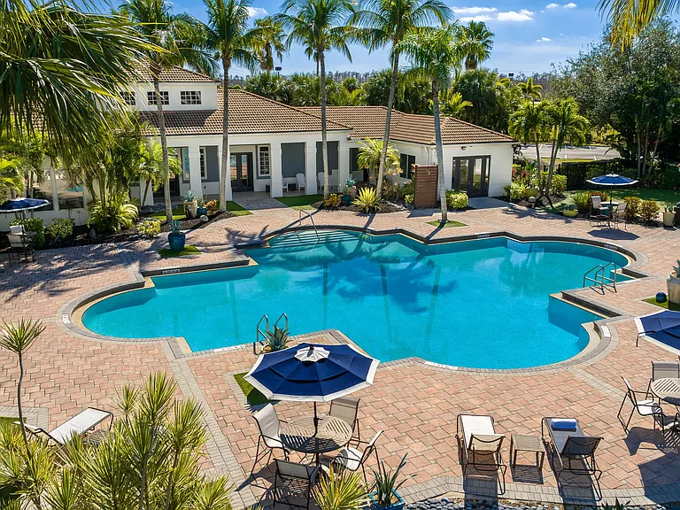 Enjoy the Florida sun at our resort-style pool featuring shaded seatings, poolside loungers, and tropical greenery.