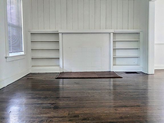 Living room bookcase. Dining room to the left of the living room.