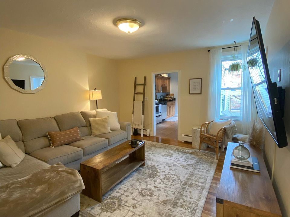 Large light filled living room with hardwood floors