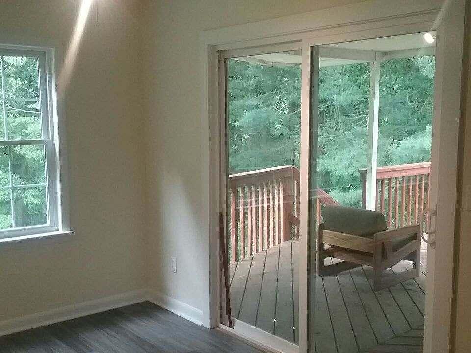 View from sun room to back deck and back yard (and forest!)