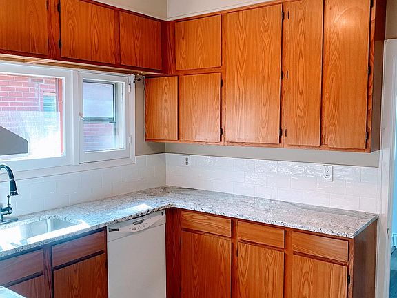 Newly updated kitchen with granite, subway tiles and vinyl plank flooring.