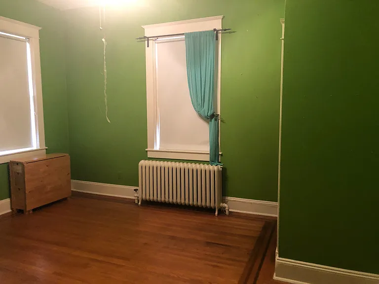 2nd large corner bedroom with 3 windows facing south and southeast. Large closet area with shelves. Table shown expands into a large table or desk and there is a large bookcase for use if desired.