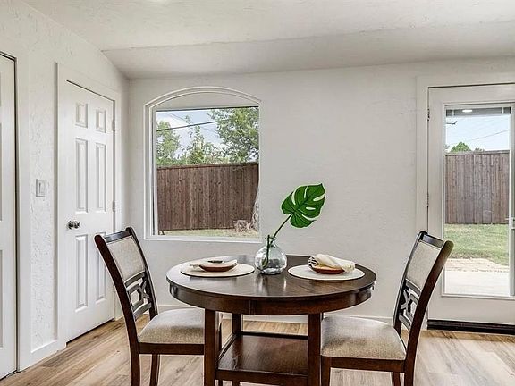 Dining space featuring light wood-style flooring and a textured wall