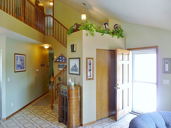 Entry & stairs. Hall leads to the den & laundry room