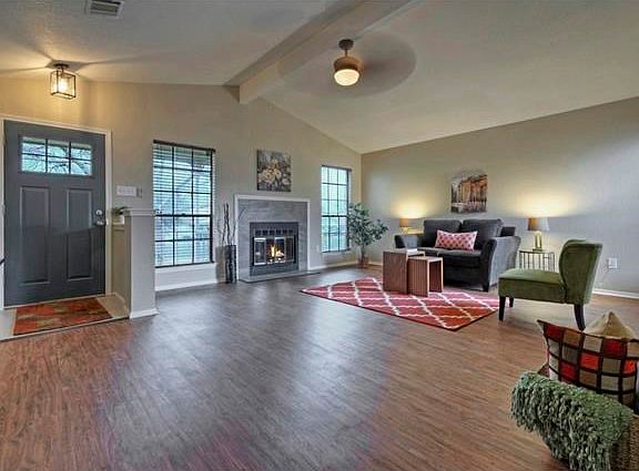 Living area featuring vaulted ceiling and fireplace